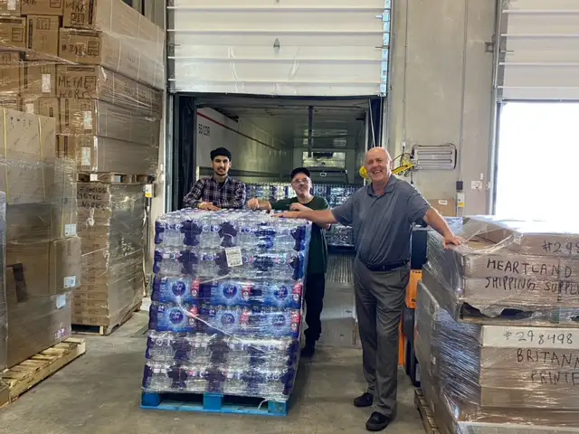 Stacey Jenkins, Director of Sales and Marketing, Thomson Terminals with some of the bottled water Trucks for Change Network carriers will be moving.